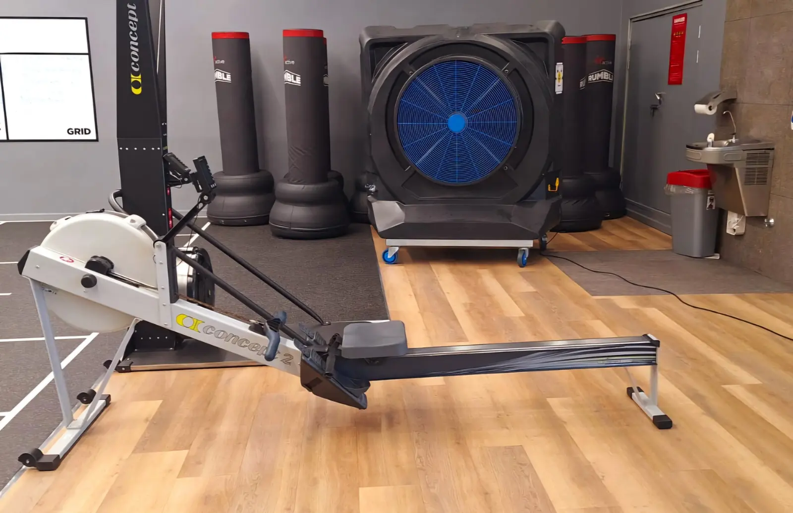 MaxCool Omega mobile evaporative cooler providing airflow beside gym equipment